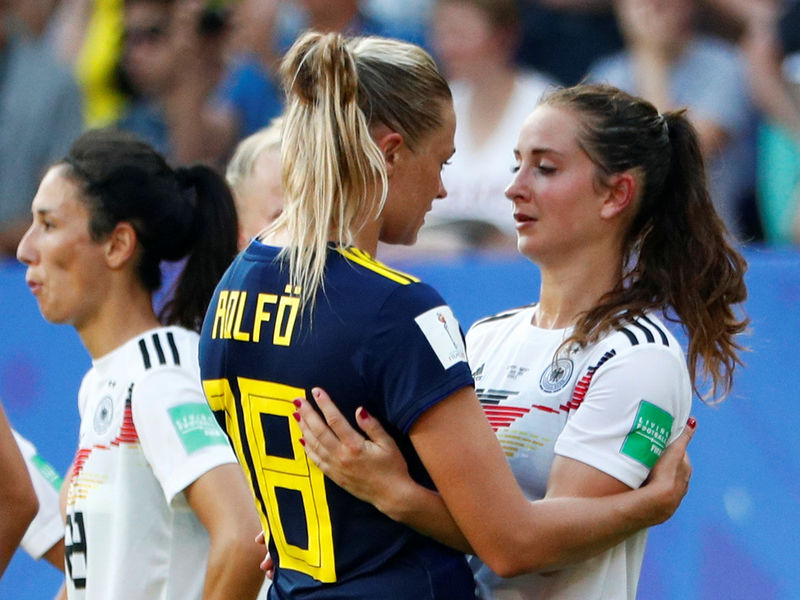 Sweden Women Player hugs Germany Women Player
